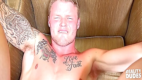 Busty blonde in a tattooed pussy video with deepthroat