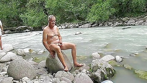 hot girl is on the riverbank and she is showing her legs