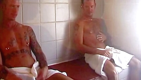 Brunette woman with tattooed tits rides two huge cocks