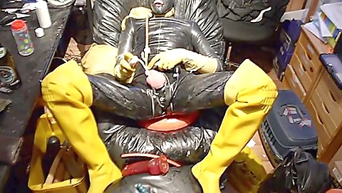 Latex fetish toy playing with a dildo in a sexy lingerie