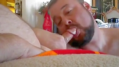 Chubby chick giving a deep throat blowjob in front of a bear